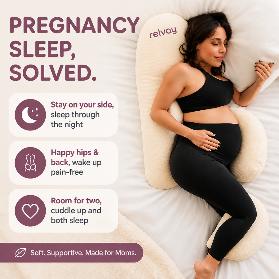 Expecting mother resting on the maternity pillow while her partner keeps his own half of the bed